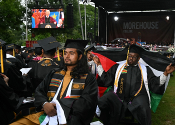 Graduating students turn their back on US President Joe Biden as he delivers a commencement address during Morehouse College's graduation ceremony in Atlanta, Georgia on May 19, 2024 / ©AFP