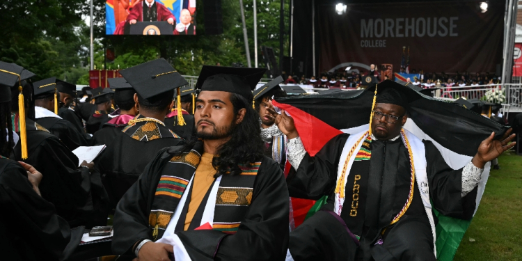 Graduating students turn their back on US President Joe Biden as he delivers a commencement address during Morehouse College's graduation ceremony in Atlanta, Georgia on May 19, 2024 / ©AFP