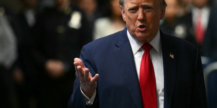 Former US president Donald Trump speaks to the press on arrival at his trial for allegedly covering up hush money payments linked to extramarital trysts / ©AFP