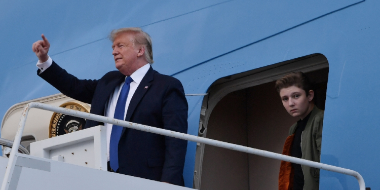 Former US president Donald Trump, pictured with son Barron in 2020, complained that he would be unable to attend the graduation ceremony -- but ultimately was granted a trial recess / ©AFP