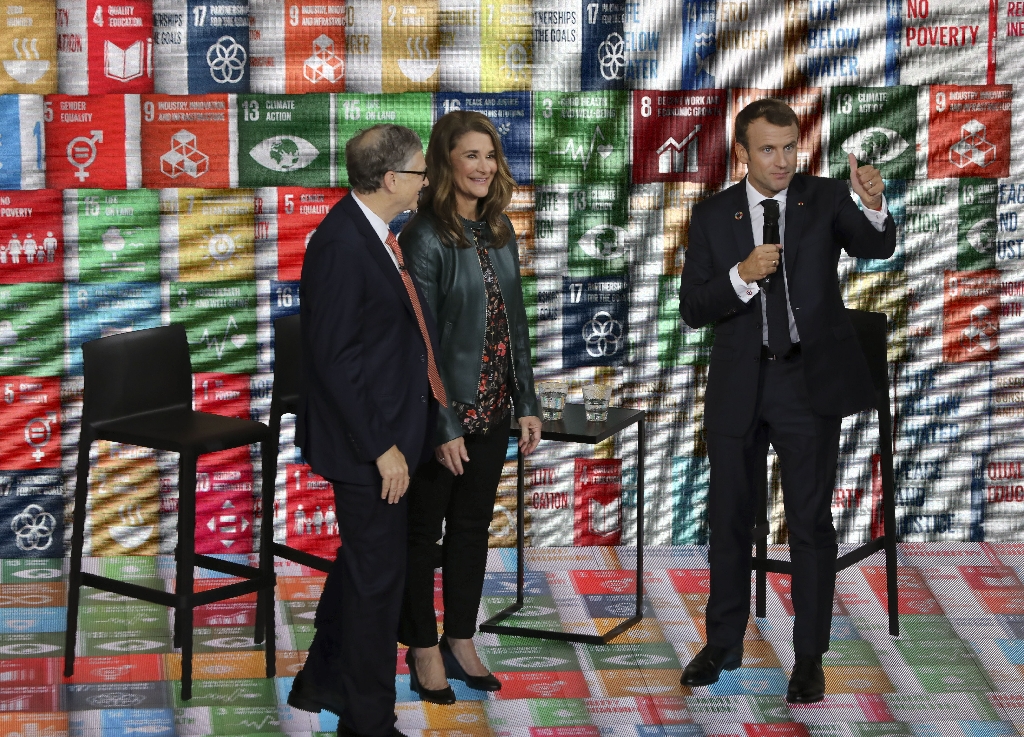 Melinda French Gates, pictured in 2018 with Bill Gates (left) and French President Emmanuel Macron, has pledged to use her fortune to help women and families  / ©AFP