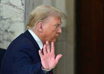 Former US president Donald Trump waves after speaking to the media during his civil fraud trial in New York in October 2023 / ©AFP