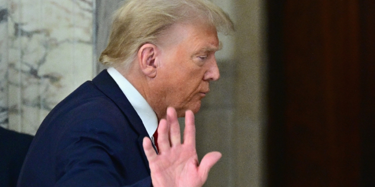 Former US president Donald Trump waves after speaking to the media during his civil fraud trial in New York in October 2023 / ©AFP