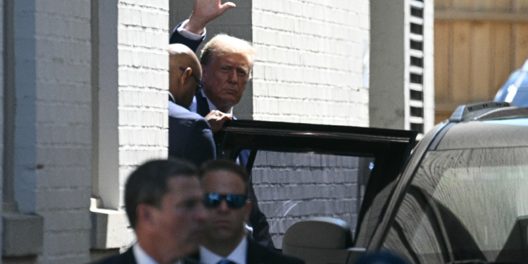 Former US president Donald Trump waves as he departs the Capitol Hill Club following a meeting with US House Republicans on Capitol Hill in Washington, DC, on June 13, 2024 / ©AFP