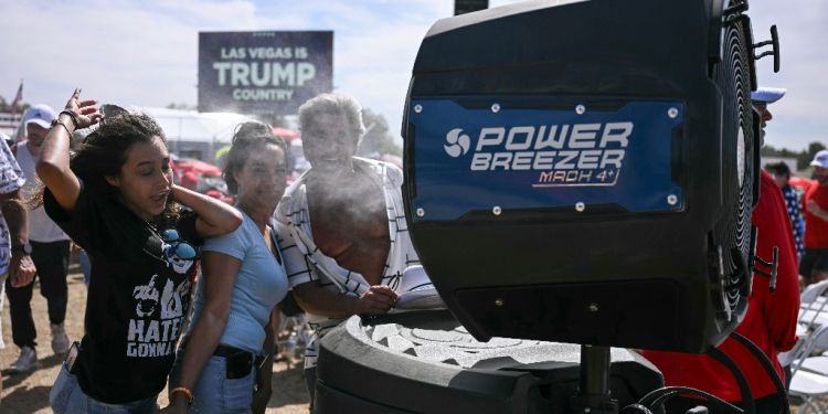 Donald Trump supporters cool off as they attend the Republican candidate's rally in Las Vegas on June 9, 2024 / ©AFP