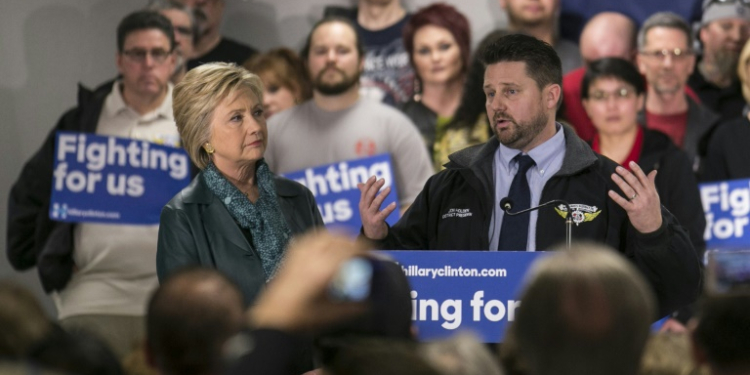 Jon Holden -- seen here with Hillary Clinton in March 2016 -- is president of the International Association of Machinists and Aerospace Workers for District 751, which represents some 30,000 Boeing workers. ©AFP