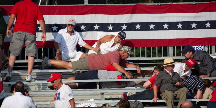 Trump supporters are seen laying in the stands after shots were fired at Republican candidate Donald Trump at a campaign event in Butler, Pennsylvania / ©AFP