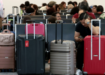 Passengers crowded into airports to wait for news as dozens of flights were cancelled. ©AFP