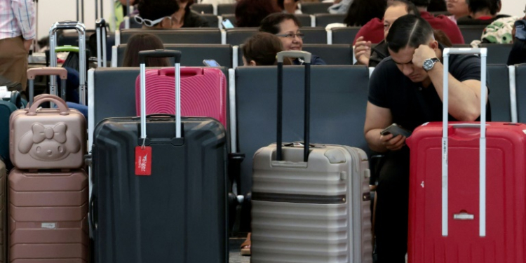 Passengers crowded into airports to wait for news as dozens of flights were cancelled. ©AFP