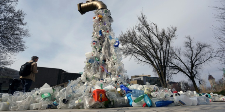 A sculpture titled "Giant Plastic Tap" by Canadian artist Benjamin Von Wong is displayed outside the fourth session of the UN Intergovernmental Negotiating Committee on Plastic Pollution in Ottawa, Canada, on April 23, 2024. ©AFP