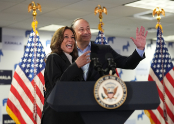 US Vice President and Democratic presidential candidate Kamala Harris and Second Gentleman Doug Emhoff acknowledge the crowd before Harris spoke at her campaign headquarters in Wilmington, Delaware, on July 22, 2024.  Harris on Monday compared her election rival Donald Trump to predators and cheaters, as she attacked the first former US leader to be convicted of a crime. / ©AFP