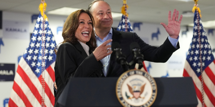 US Vice President and Democratic presidential candidate Kamala Harris and Second Gentleman Doug Emhoff acknowledge the crowd before Harris spoke at her campaign headquarters in Wilmington, Delaware, on July 22, 2024.  Harris on Monday compared her election rival Donald Trump to predators and cheaters, as she attacked the first former US leader to be convicted of a crime. / ©AFP