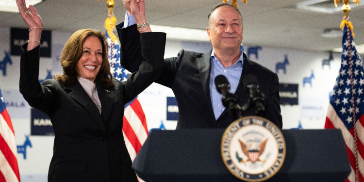 US Vice President and Democratic presidential candidate Kamala Harris and Second Gentleman Doug Emhoff acknowledge the crowd before speaking at her campaign headquarters in Wilmington, Delaware, on July 22, 2024.  Harris on January 22, won the crucial backing of Democratic heavyweight Nancy Pelosi to lead the party against Donald Trump in November after Joe Biden's stunning exit from the 2024 race. As the endorsements stacked up, the 59-year-old Harris made her first public appearance since Biden's announcement in a ceremony at the White House where she warmly praised the outgoing president's unmatched achievements.  / ©AFP