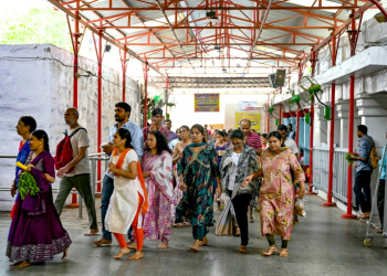 Hindu devotees walk around the inner chamber of Chilkur Balaji temple near  Hyderabad, many hoping the gods will look favourably on their US visa application. ©AFP