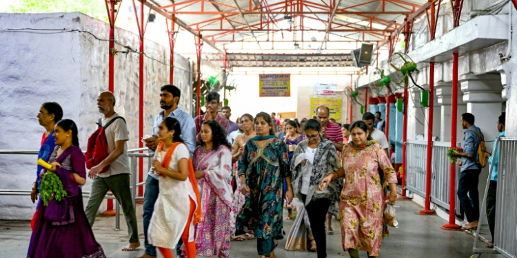 Hindu devotees walk around the inner chamber of Chilkur Balaji temple near  Hyderabad, many hoping the gods will look favourably on their US visa application. ©AFP