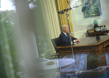 Seen through a window, US President Joe Biden speaks during an address to the nation from the Oval Office of the White House in Washington, DC on July 14, 2024.  / ©AFP