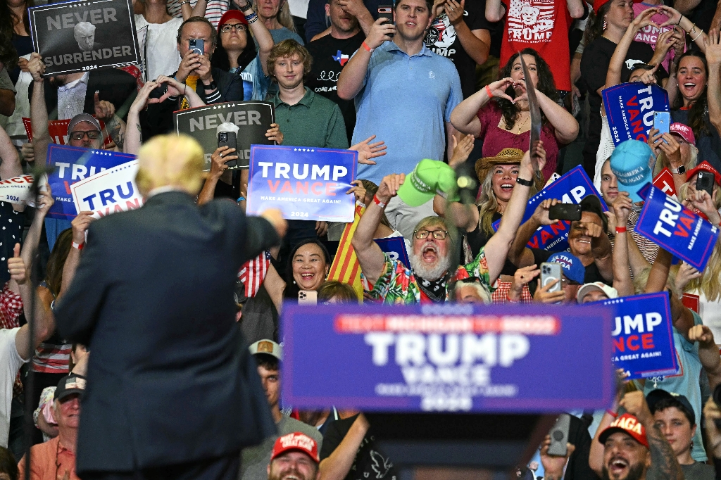 US President Donald Trump gestures at the crowd in Grand Rapids, Michigan, where he made a triumphant return to the campaign trail Saturday / ©AFP