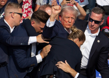 Donald Trump is seen with blood on his face surrounded by Secret Service agents as he is taken off the stage after an attempted assassination in Pennsylvania / ©AFP