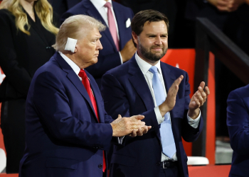 US presidential candidate Donald Trump (L), wounded after a weekend assassination attempt, applauds next to his running mate J.D. Vance during the first day of the 2024 Republican National Convention in Milwaukee, Wisconsin, July 15, 2024 / ©AFP