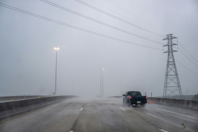 A truck drives through heavy rain in Houston, Texas, during Hurricane Beryl on July 8, 2024. ©AFP