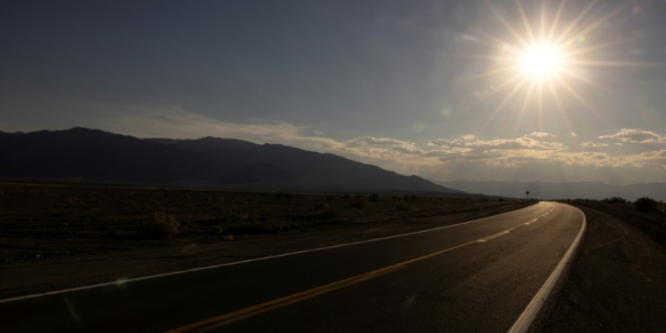 The sun sets over a highway in California . ©AFP