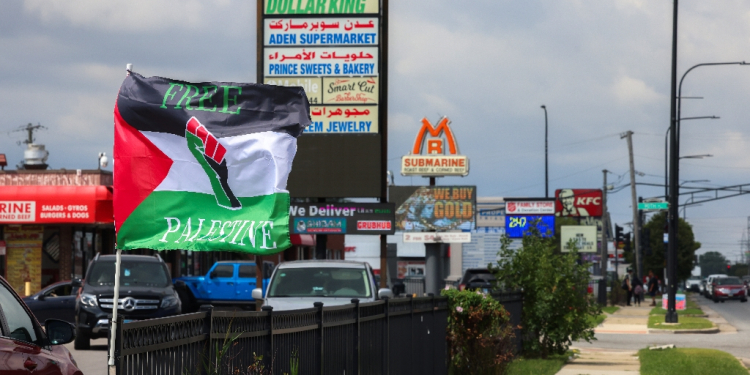 Palestinian flags flutter in the wind, shops display signs in both Arabic and English, and posters call for demonstrations against steadfast US military support of Israel  / ©AFP