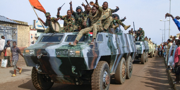 People cheer members of Sudan's armed forces taking part in a military parade held on Army Day / ©AFP