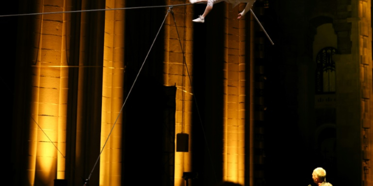 Philippe Petit marked the 50th anniversary of his walk between New York's Twin Towers with a performance in a Manhattan cathedral . ©AFP