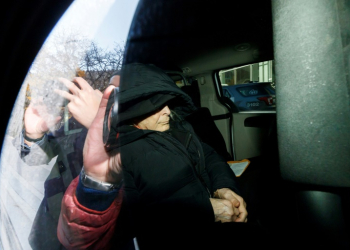 Seen through a police vehicle window, Canadian fashion mogul Peter Nygard leaves a Toronto courthouse in November 2023 after being found guilty of four counts of sexual assault. ©AFP