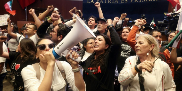 Demonstrators are seen inside Mexico's Senate after storming the building on September 10 to disrupt a debate on controversial judicial reforms. ©AFP