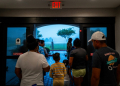 Families watch Hurricane Francine from the entrance of their hotel on September 11, 2024 in Houma, Louisiana. ©AFP