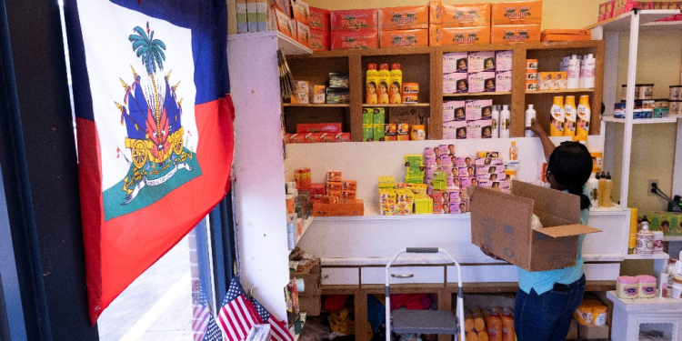 Creations Market shop owner Philomene Philostin, a naturalized US citizen of Haitian origin, shelves merchandise in her store that caters mainly to Haitian residents in Springfield, Ohio, on September 13, 2024 / ©AFP