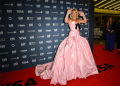 British actress Florence Pugh laughs it up on the red carpet at the Toronto film festival in a pink Tamara Ralph ball gown. ©AFP