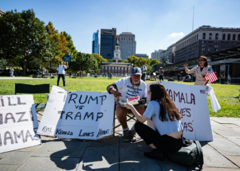 A supporter of former US president and Republican presidential nominee Donald Trump sits outside of the National Constitution Center, ahead of the presidential debate . ©AFP