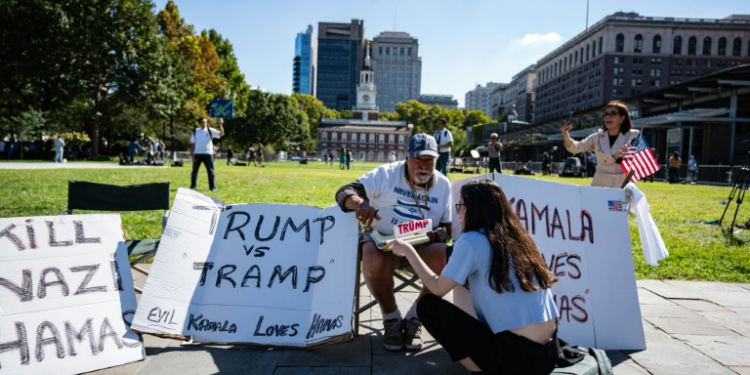 A supporter of former US president and Republican presidential nominee Donald Trump sits outside of the National Constitution Center, ahead of the presidential debate . ©AFP