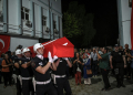 An honour guard carries the coffin of activist Aysenur Ezgi Eygi, who was killed in the West Bank, to a morgue after her remains arrived in Turkey on Friday. ©AFP