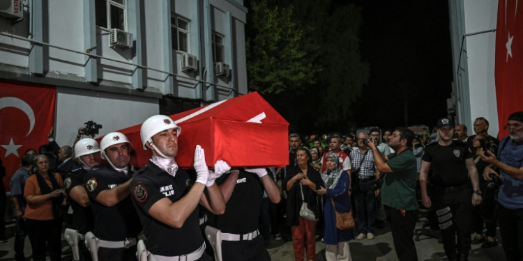 An honour guard carries the coffin of activist Aysenur Ezgi Eygi, who was killed in the West Bank, to a morgue after her remains arrived in Turkey on Friday. ©AFP