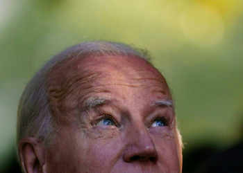 Not a joke! US President Joe Biden really did try on a red Donald Trump campaign hat -- as a gesture of unity in meeting with a voter / ©AFP