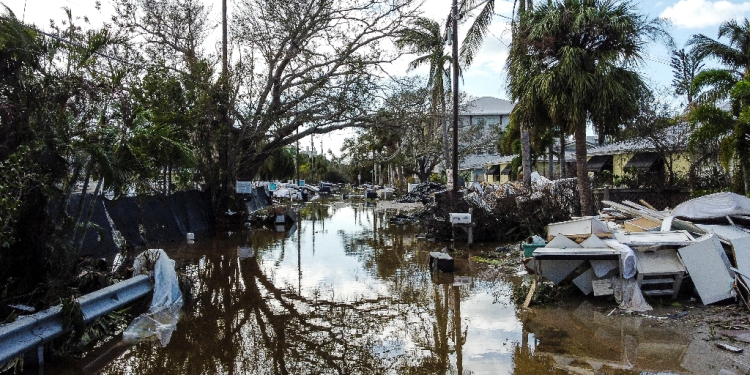 A flooded street with debris in the aftermath of Hurricane Milton in Siesta Key, Florida, where the storm made landfall / ©AFP