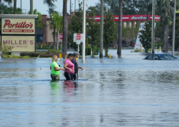 People walk through flooded streets in the Southeast Seminole Heights neighborhood of Tampa, Florida, inundated by Hurricane Milton, on October 10, 2024. ©AFP