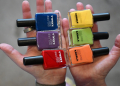 Nail polishes from the Kamala Harris-promoting 'Joyful Warrior' set, include a green polish called 'Kamala Is Brat,' an orange polish called 'The Prosecutor' and a classic red named 'Cat Lady'  / ©AFP