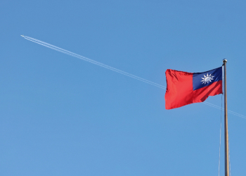 A Taiwan flag flies over the capital, Taipei, in October 2024. The self-ruled island is closely watching the US election for signs of policy shifts that could impact tensions with China / ©AFP