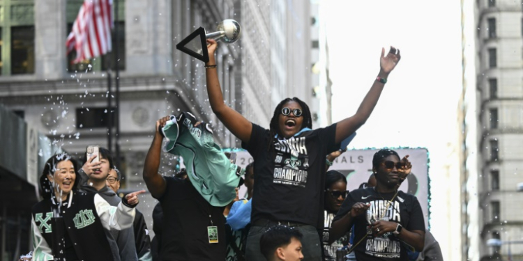 A convoy of floats and open-top buses processed up Manhattan's 'Canyon of Heroes' to City Hall with star player, MVP Jonquel Jones leading proceedings . ©AFP