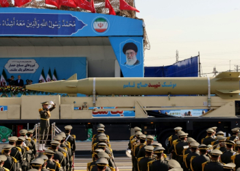 Iran's president looks on, as a 'Qasem Soleimani' missile is displayed during an annual military parade in Tehran. ©AFP