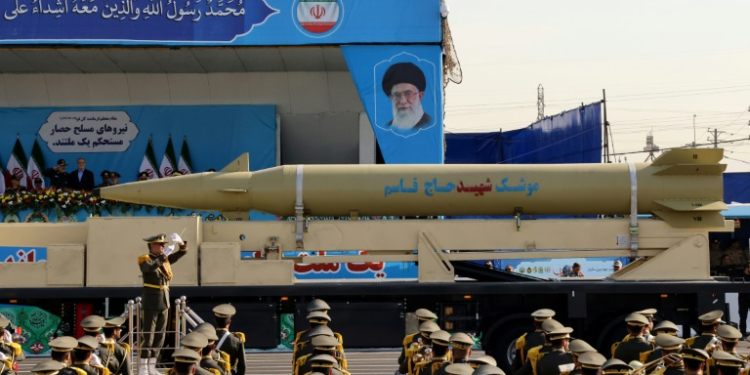 Iran's president looks on, as a 'Qasem Soleimani' missile is displayed during an annual military parade in Tehran. ©AFP