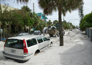 A Florida Army National Guard loader moves debris from the Pass-A-Grille section of St. Petersburg ahead of Hurricane Milton's expected landfall . ©AFP