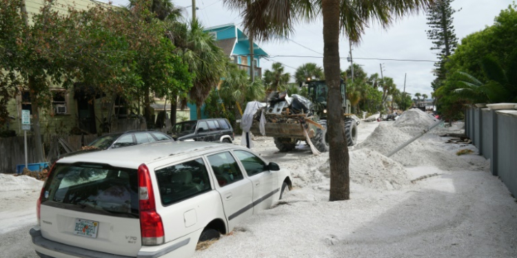 A Florida Army National Guard loader moves debris from the Pass-A-Grille section of St. Petersburg ahead of Hurricane Milton's expected landfall . ©AFP