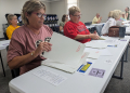 Lee County, Georgia poll workers Debbie Jack (L) and Donna Mathis (R) practice counting ballots as part of new election hand count rules on October 2, 2024 / ©AFP