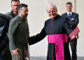 Ukraine's President Volodymyr Zelensky (L) is welcomed by Prefect of the Pontifical House, Monsignor Leonardo Sapienza (R) at San Damaso courtyard, before his meeting with Pope Francis. ©AFP