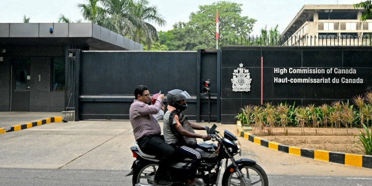 A motorist rides past the entrance of the Canadian High Commission in New Delhi as tensions between the countries escalates / ©AFP